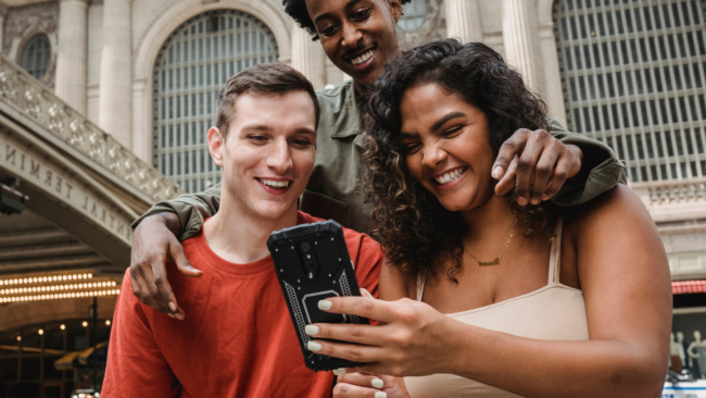 friends-looking-at-phone-together-having-a-fun-time